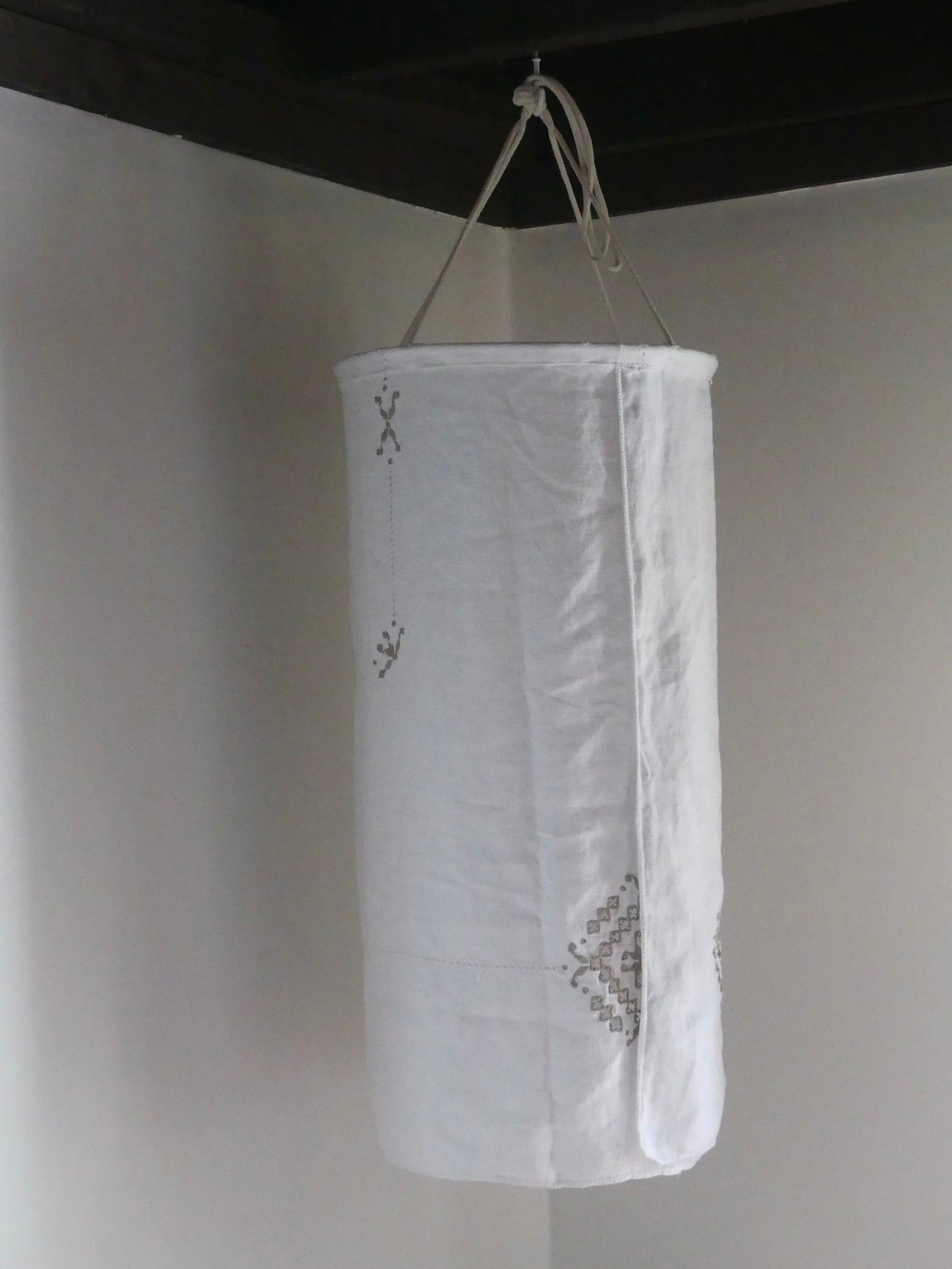 White linen lantern with tan embroidery detail