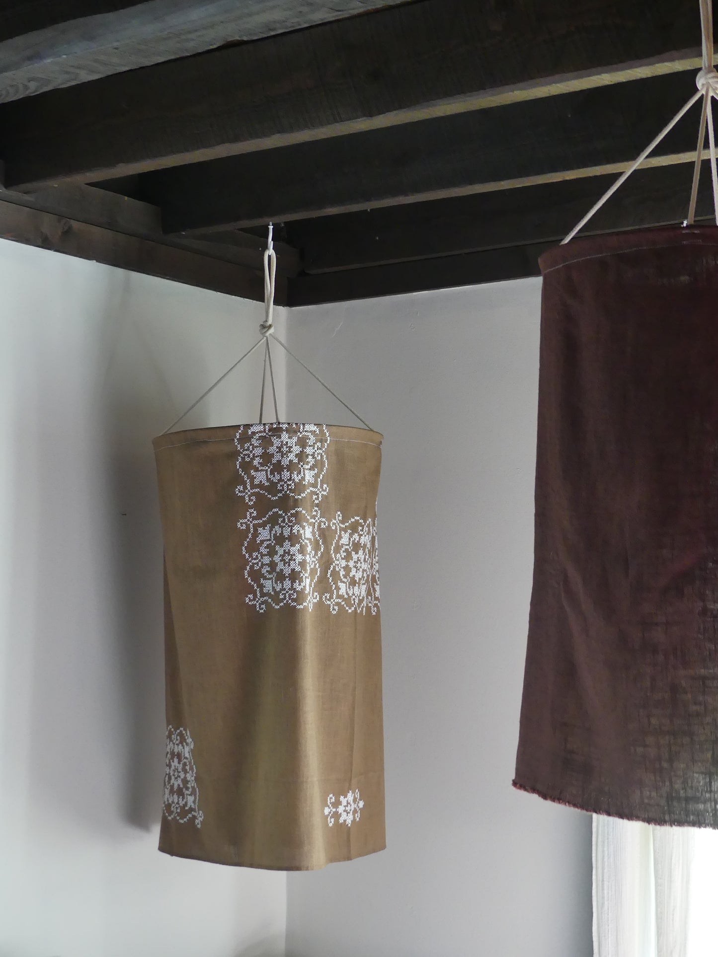 Brown linen lantern with white embroidery detail