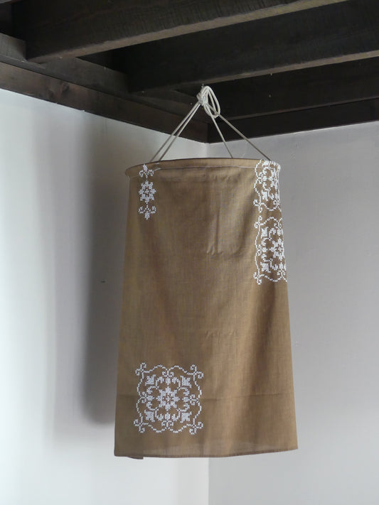 Brown linen lantern with white embroidery detail