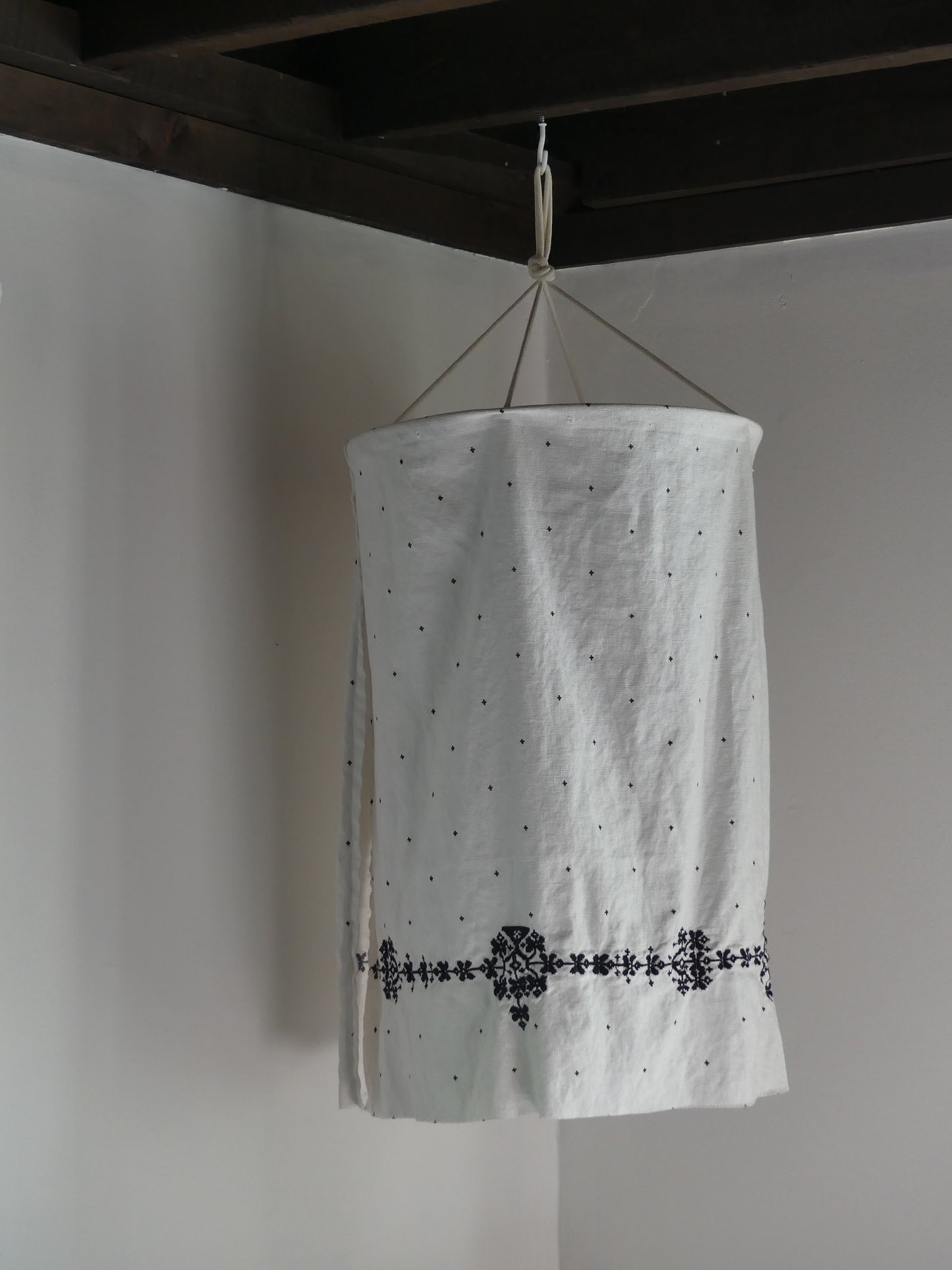 White linen lantern with black embroidery detail