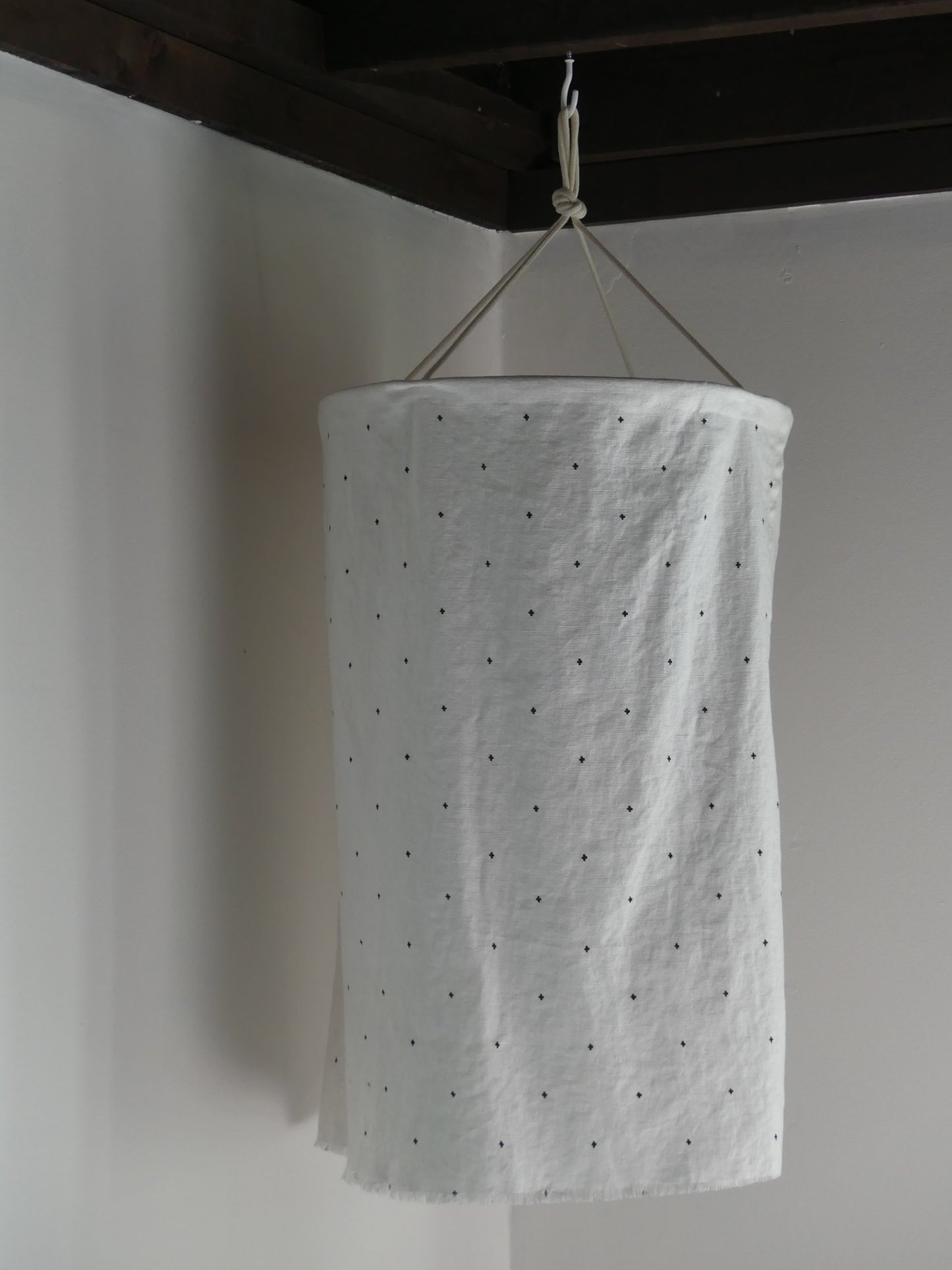 White linen lantern with black embroidery detail pattern