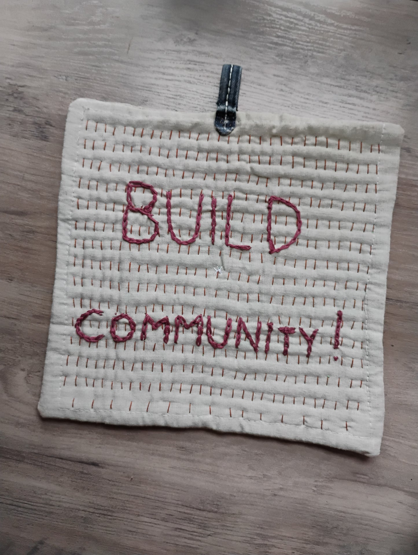 BUILD COMMUNITY pot holder trivet