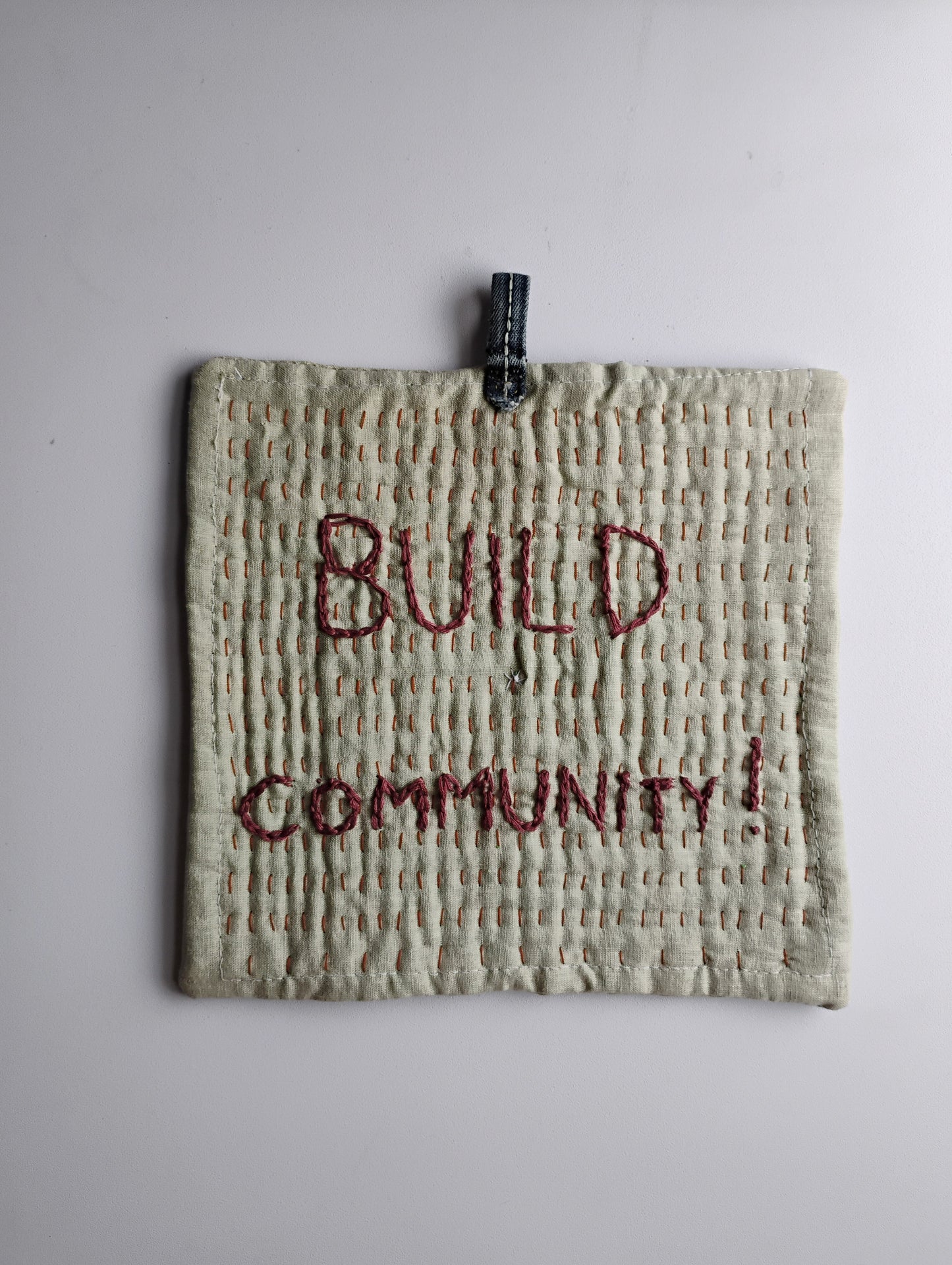 BUILD COMMUNITY pot holder trivet