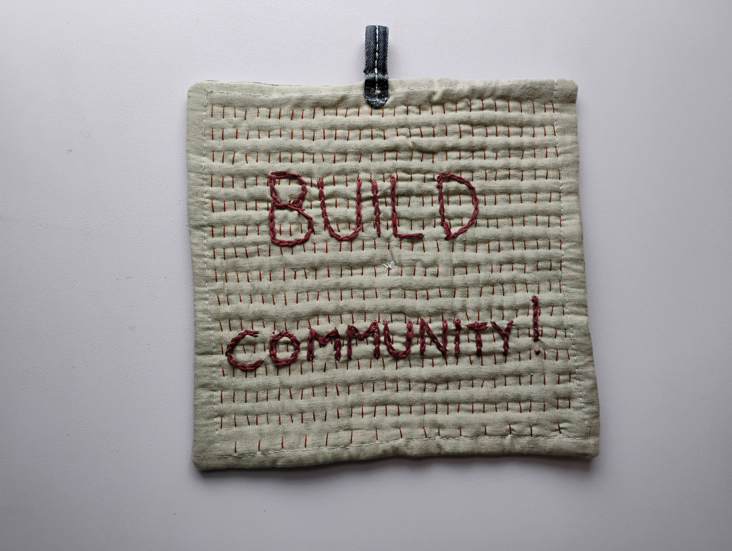 BUILD COMMUNITY pot holder trivet