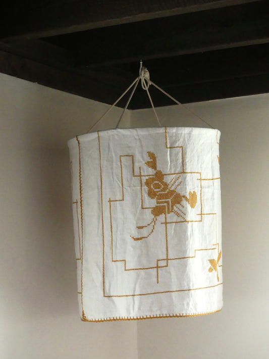 White linen lantern with mustard embroidery detail