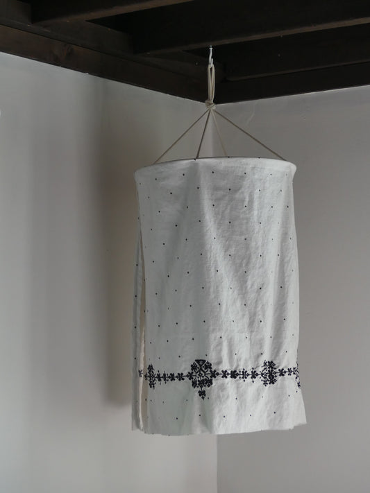 White linen lantern with black embroidery detail
